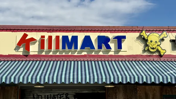 Killmart maze storefront at Kings Island, a boarded-up grocery store with graffiti