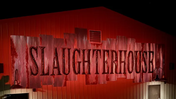 The Slaughter House maze building at Kings Island lit deep red at night